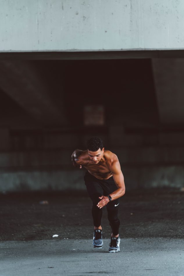 Topless man about to sprint