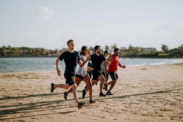 group of runners on the beach