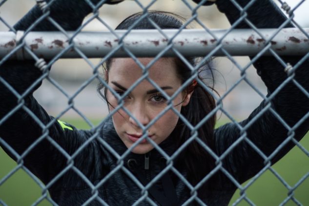 Woman behind fence