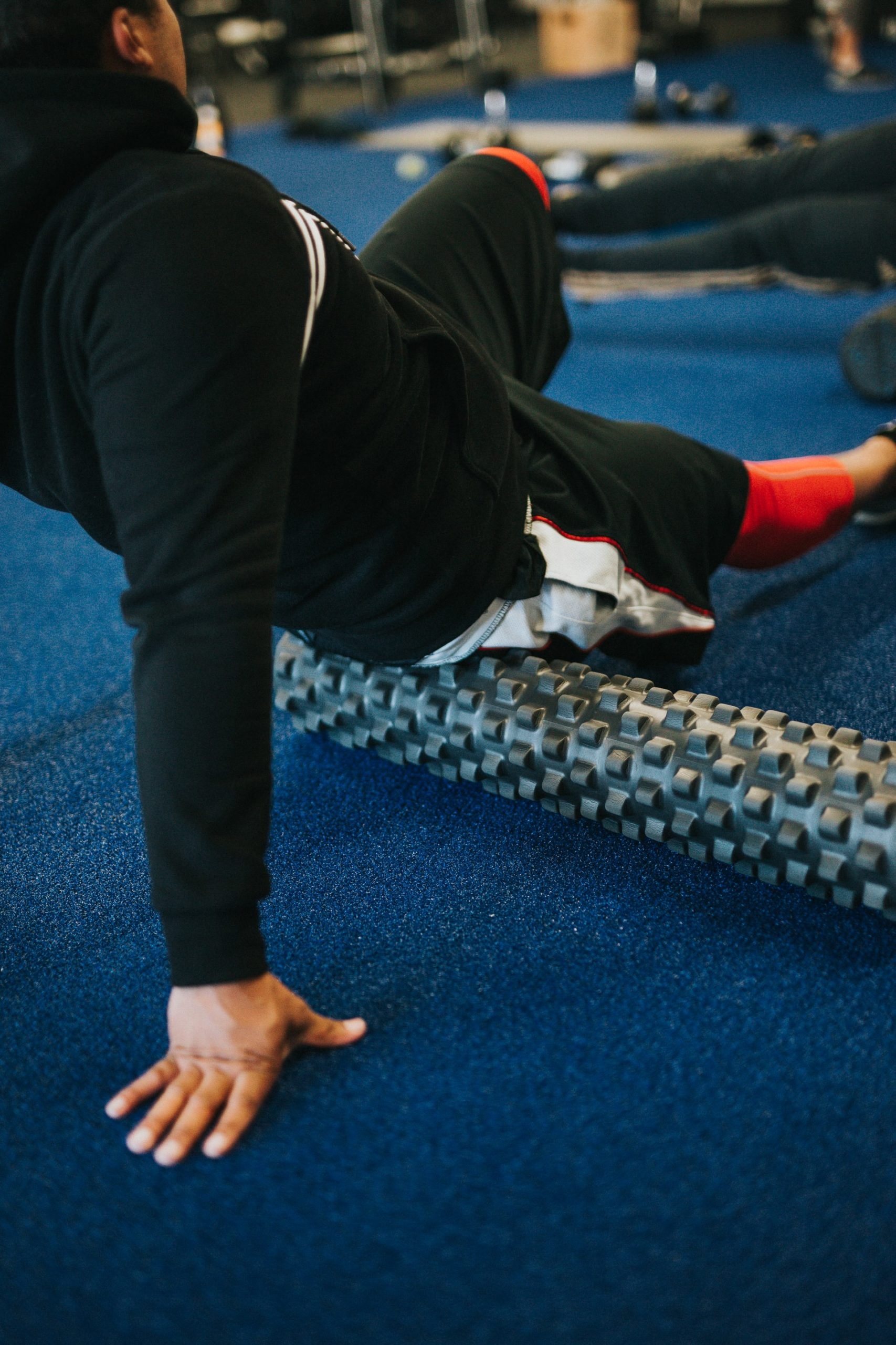 Person using a foam roller at the gym