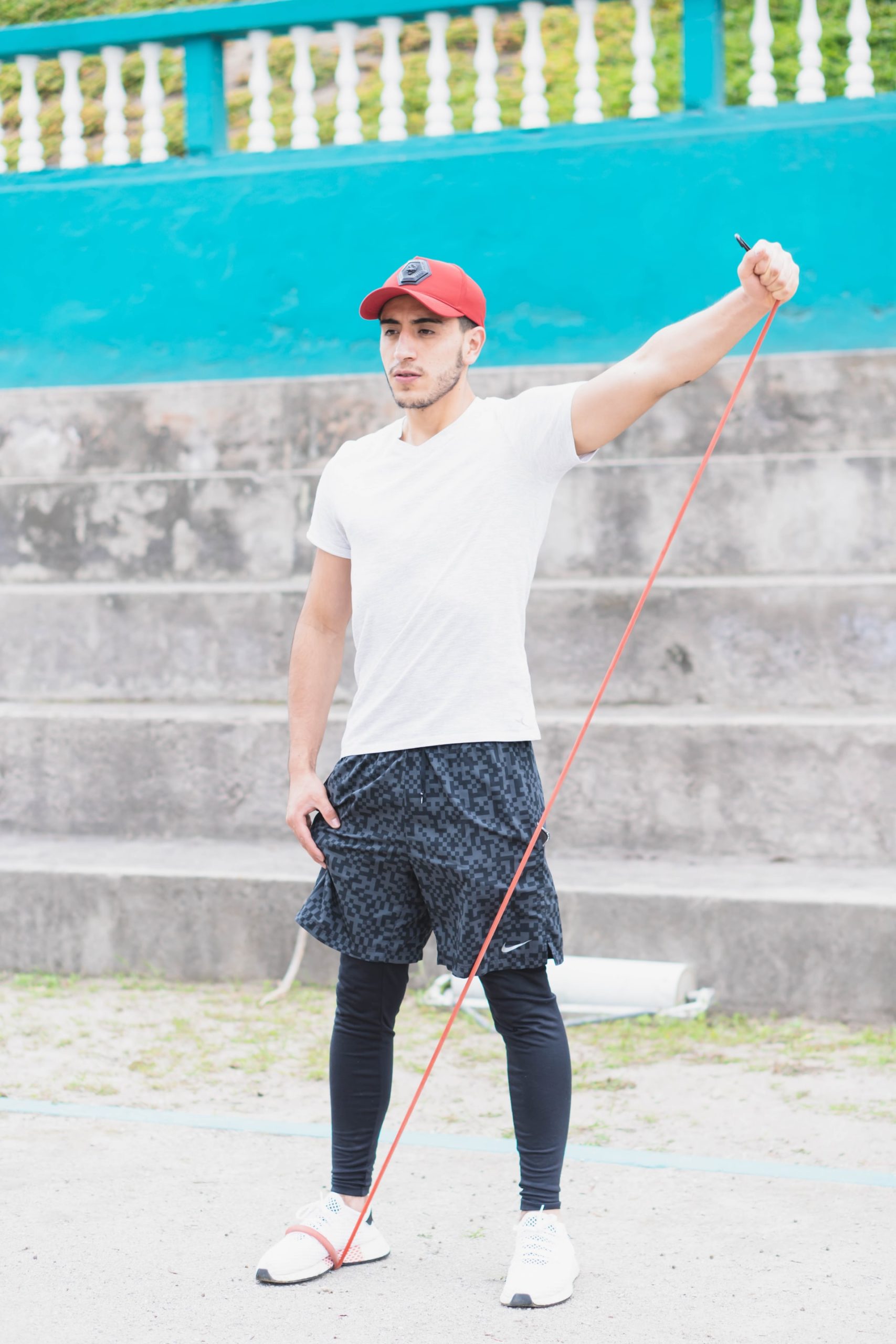 Man training with resistance bands shoulder exercise