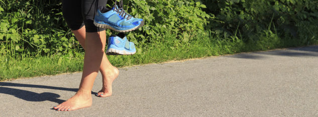 Barefoot running holding shoes