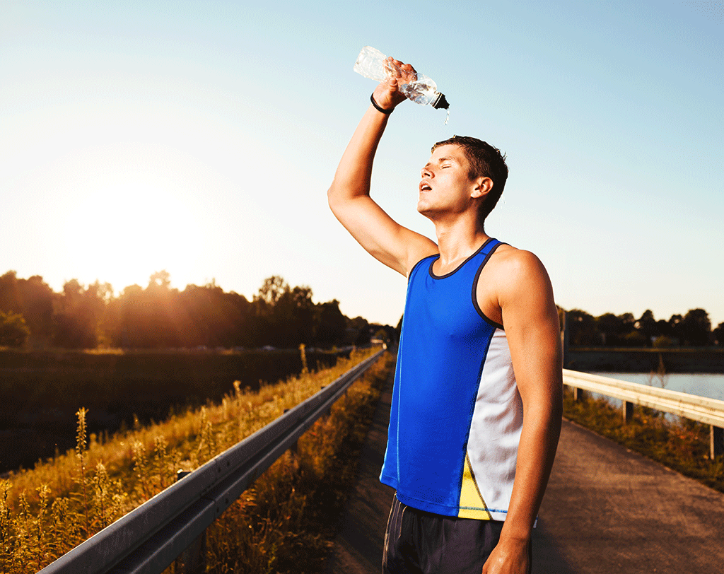 Runner tipping water on his head 