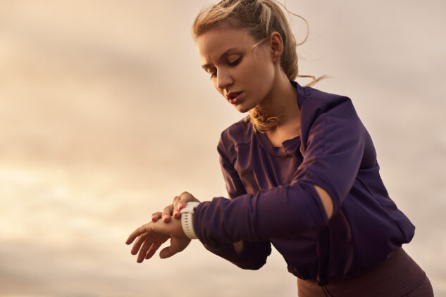 Sportswoman checking HRV on wristwatch