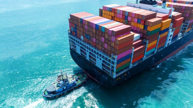 Stern of large cargo container ship import export container box on the ocean sea on blue sky back ground concept transportation logistic and service to customer and supply change.